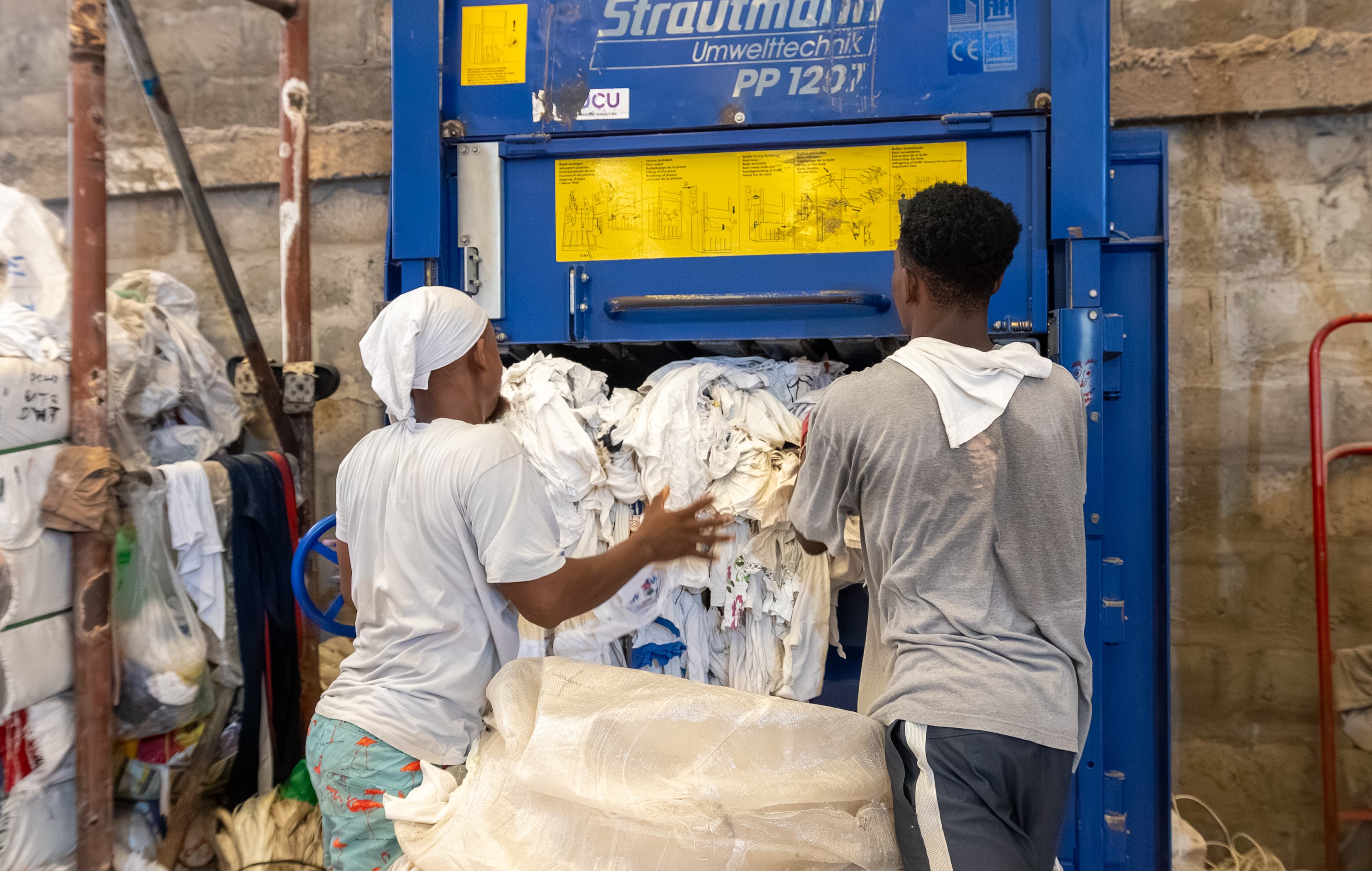 Workers loading baler
